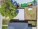 Overhead aerial view of a home with green tree coverage and a fenced in yard at 204 Ne Jefferson N Cir, St Petersburg, FL 33702