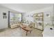 Cozy living room with tile floors, neutral-toned furniture, and a bright window creating a welcoming atmosphere at 204 Ne Jefferson N Cir, St Petersburg, FL 33702