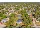 An aerial view of a house surrounded by lush trees within a quiet neighborhood at 4313 Appleton Ter, North Port, FL 34286