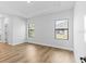 A spacious bedroom with hardwood flooring, natural light, tray ceiling, and recessed lighting at 4313 Appleton Ter, North Port, FL 34286