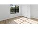 A bedroom with wood-look flooring and trim and features a large window and closet provides an inviting space at 4313 Appleton Ter, North Port, FL 34286