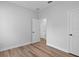 Neutral bedroom with modern flooring, a large window, and white trim at 4313 Appleton Ter, North Port, FL 34286