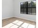A bright bedroom with wood look flooring and a large window with trim create an inviting and serene space at 4313 Appleton Ter, North Port, FL 34286