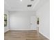 A bedroom features wood floors, recessed lighting, tray ceiling, and a door to another room at 4313 Appleton Ter, North Port, FL 34286