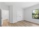 Sunlit bedroom with neutral walls, wood-look floors, and a view to the outdoors at 4313 Appleton Ter, North Port, FL 34286