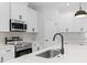 Bright kitchen features stainless steel appliances, a quartz countertop, and modern fixtures at 4313 Appleton Ter, North Port, FL 34286