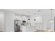 A kitchen with stainless steel appliances, and a large island with pendant lighting is a chef's dream at 4313 Appleton Ter, North Port, FL 34286