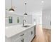 Modern kitchen featuring quartz countertop, stainless steel appliances, and kitchen island with a sink at 4313 Appleton Ter, North Port, FL 34286