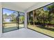 View of the backyard from a screened lanai, filled with natural light at 4313 Appleton Ter, North Port, FL 34286