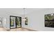 Open living room featuring modern lighting and large windows offering bright, natural light at 4313 Appleton Ter, North Port, FL 34286