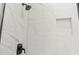 Modern shower featuring marble-style tile and a convenient in-wall niche for storage at 4313 Appleton Ter, North Port, FL 34286