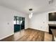 Dining room with sliding glass doors and modern light fixture at 10019 Warm Stone St, Thonotosassa, FL 33592