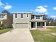 Two-story home features a neutral exterior, attached two-car garage and well-manicured lawn at 10019 Warm Stone St, Thonotosassa, FL 33592