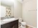 Bathroom includes a single sink vanity with granite countertops, a toilet, and a shower at 13001 Pennybrook Dr, Riverview, FL 33579