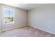 Neutral toned bedroom with a large window providing plenty of natural light at 13001 Pennybrook Dr, Riverview, FL 33579