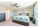 This bedroom boasts a ceiling fan, an abundance of wall decor, and a pleasant view at 13001 Pennybrook Dr, Riverview, FL 33579
