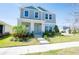 Charming two-story home boasts a neatly landscaped front yard, enhancing its curb appeal and welcoming ambiance at 13001 Pennybrook Dr, Riverview, FL 33579