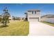 Well-maintained home with a manicured lawn, a long driveway, and a two-car garage at 13001 Pennybrook Dr, Riverview, FL 33579