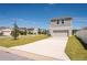 New home with a pristine lawn and a long driveway leading to a two-car garage at 13001 Pennybrook Dr, Riverview, FL 33579