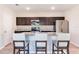 Elegant kitchen with stainless steel appliances, dark wood cabinetry, and a central island with seating at 13001 Pennybrook Dr, Riverview, FL 33579