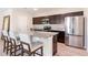 Contemporary kitchen featuring stainless steel appliances, granite countertops, and a convenient breakfast bar at 13001 Pennybrook Dr, Riverview, FL 33579