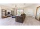 Bright living room featuring wood-look floors, modern furniture, and a ceiling fan for added comfort at 13001 Pennybrook Dr, Riverview, FL 33579