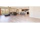 Spacious living room and kitchen area with wood flooring, lots of light, and a comfortable seating area at 13001 Pennybrook Dr, Riverview, FL 33579