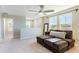 Well-lit loft area with a comfortable couch, ceiling fan, and windows offering a view outside at 13001 Pennybrook Dr, Riverview, FL 33579