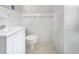 Bright and tidy white-tiled bathroom with a toilet and sleek vanity sink at 1540 David Pl, Englewood, FL 34223