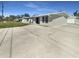 Home exterior features a concrete driveway and a well-maintained facade with classic detailing at 1540 David Pl, Englewood, FL 34223