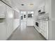 Bright kitchen with white cabinetry, modern appliances, and an open design, with outdoor views at 1540 David Pl, Englewood, FL 34223