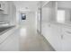 Bright kitchen featuring white cabinets and appliances, as well as smooth surface floors and plenty of light at 1540 David Pl, Englewood, FL 34223