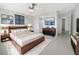 Serene main bedroom with a modern design, a mounted television, and ample closet space at 1540 David Pl, Englewood, FL 34223