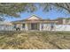 A view of the home's backyard featuring a white fence and sliding glass doors leading inside at 19012 Quarry Badger Rd, Land O Lakes, FL 34638