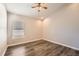 Comfortable bedroom with hardwood floors, ceiling fan, and a large window at 19012 Quarry Badger Rd, Land O Lakes, FL 34638