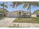 Charming single-story home with well-manicured lawn and tropical landscaping at 19012 Quarry Badger Rd, Land O Lakes, FL 34638