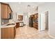 Open kitchen with stainless steel appliances, wooden cabinets, and ample counter space for cooking at 19012 Quarry Badger Rd, Land O Lakes, FL 34638