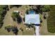Aerial view of a well maintained property with swimming pool, shed, and mature landscaping at 5769 E Price Blvd, North Port, FL 34288