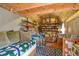 Finished attic space with exposed beam ceiling, daybed, shelving, and a carpeted floor at 5769 E Price Blvd, North Port, FL 34288