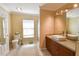 This bathroom includes vanity with sink, a large mirror, toilet and a shower with tile surround at 5769 E Price Blvd, North Port, FL 34288