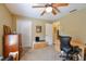 Functional bedroom with soft carpet, ceiling fan, and closet space, ideal for relaxation or work at 5769 E Price Blvd, North Port, FL 34288
