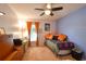Bedroom features soft carpet, bright curtains, a ceiling fan, and ample natural light at 5769 E Price Blvd, North Port, FL 34288