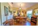 Bright dining room featuring hardwood floors, large windows, and tasteful decor at 5769 E Price Blvd, North Port, FL 34288