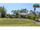 Inviting exterior featuring manicured front yard with beautiful trees and lush greenery at 5769 E Price Blvd, North Port, FL 34288