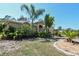 Charming home with tropical plants and mulch beds in front lawn at 5769 E Price Blvd, North Port, FL 34288