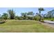 Charming single-story home featuring a well-manicured lawn and mature landscaping at 5769 E Price Blvd, North Port, FL 34288