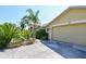 Close up view of property including driveway, garage, mature landscaping and address at 5769 E Price Blvd, North Port, FL 34288