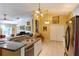 Spacious kitchen boasts stainless steel appliances, a breakfast bar, and adjacent living area at 5769 E Price Blvd, North Port, FL 34288