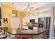 Bright kitchen featuring stainless steel appliances, stylish backsplash, and a convenient breakfast bar at 5769 E Price Blvd, North Port, FL 34288