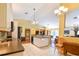 Open kitchen featuring stainless steel appliances, an island with a sink, and connection to the living room at 5769 E Price Blvd, North Port, FL 34288
